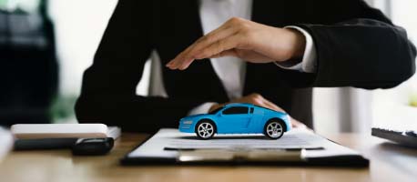 Dealership_worker_hands_protecting_small_toy_car.jpg