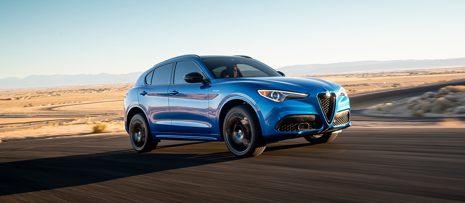 2023 Alfa Romeo Stelvio driving down a city street