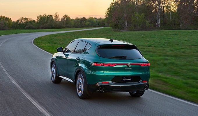 Exterior of a 2025 Alfa Romeo Tonale PHEV driving away.