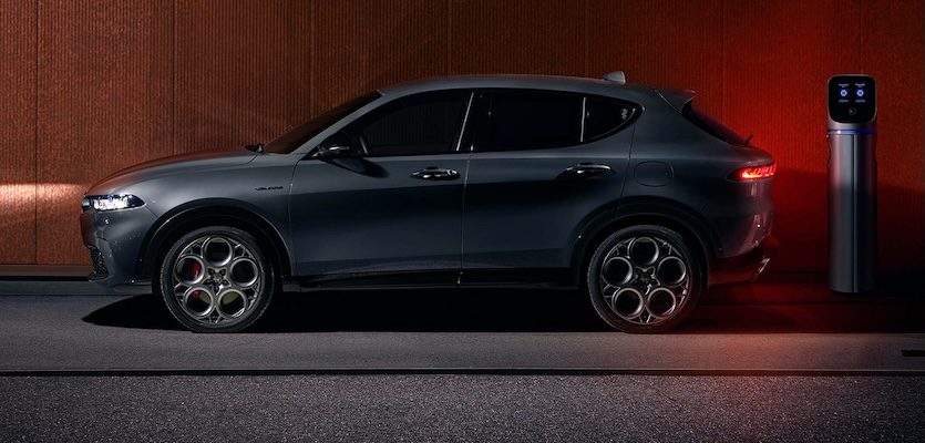 Exterior shot of a 2025 Alfa Romeo Tonale PHEV at a charging station.