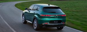 Exterior of a 2025 Alfa Romeo Tonale PHEV driving away.