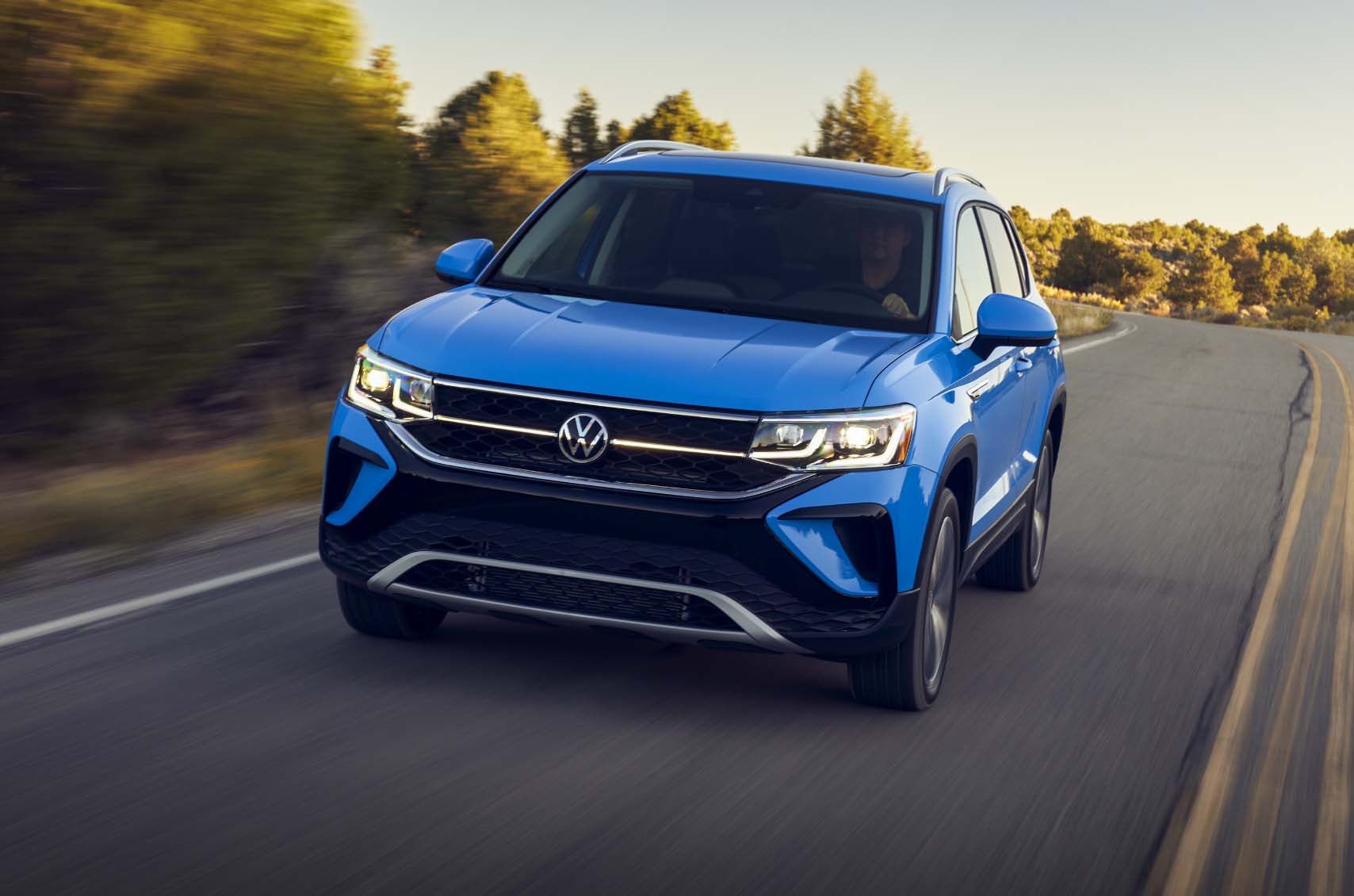Blue VW SUV driving down road