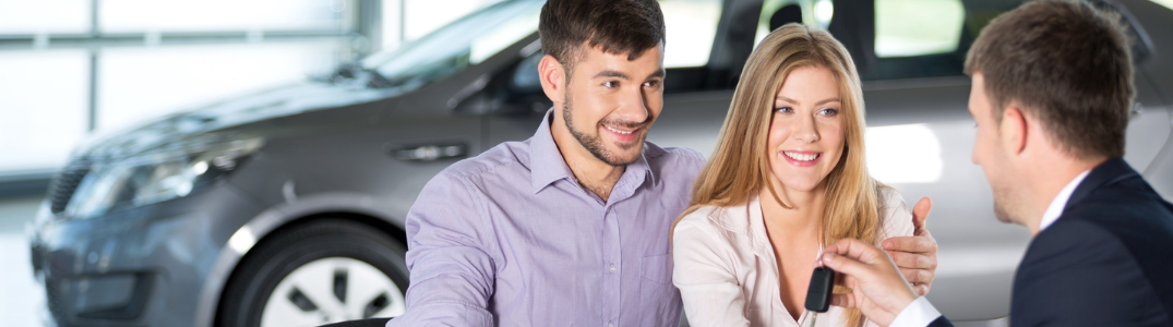 A couple talking to a care salesman