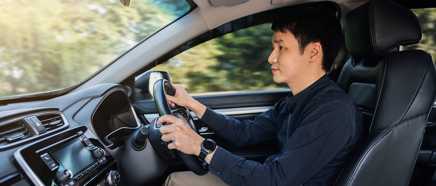 young man driving a car