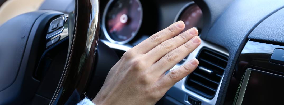 Unknown person holding hand up to vent