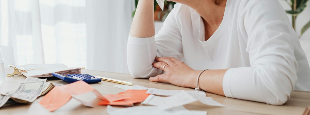 A stock photo of a person stressing over bills.