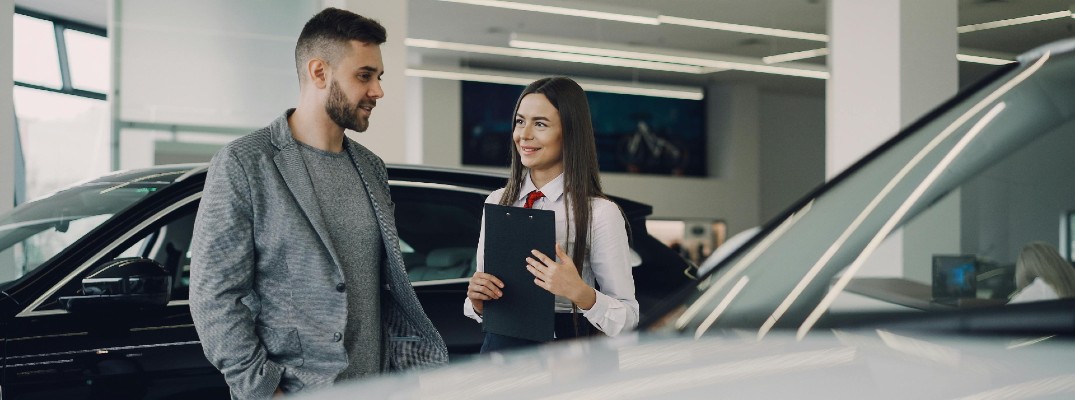 A stock photo of a person buying a car.