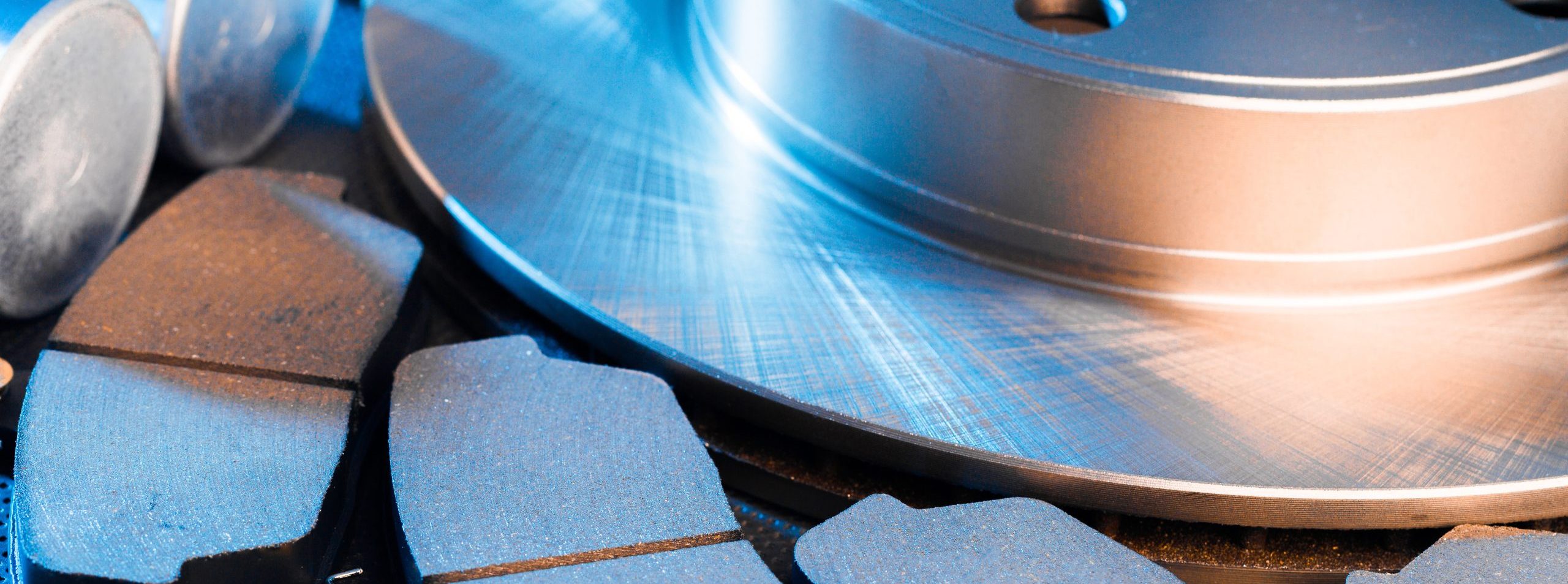 brake parts on dark background  brake pads, disc, brake hose, guides, cylinders