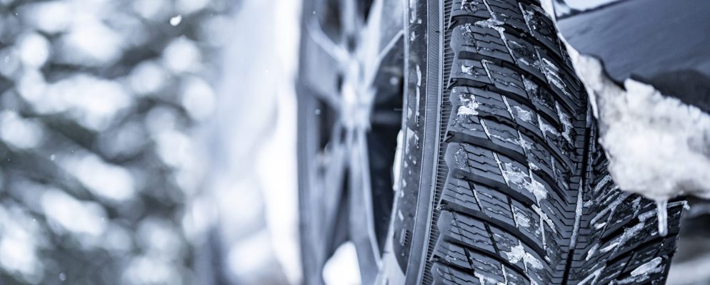A close up of winter tires caked in snow