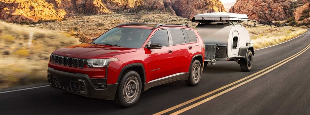 A photo of the 2026 Jeep Cherokee towing a trailer.