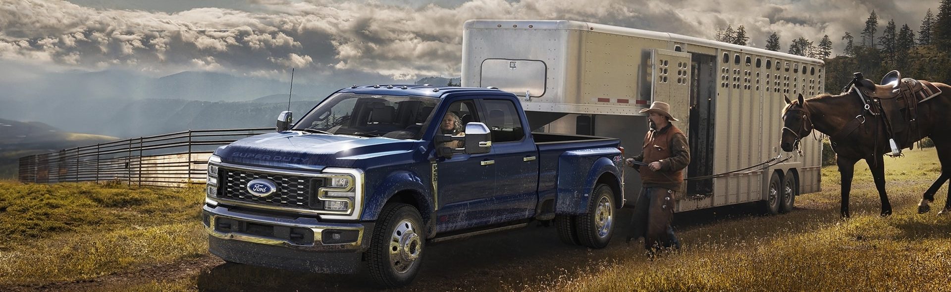 Front side view of Ford Super Duty with horse trailer and horse being led to the truck