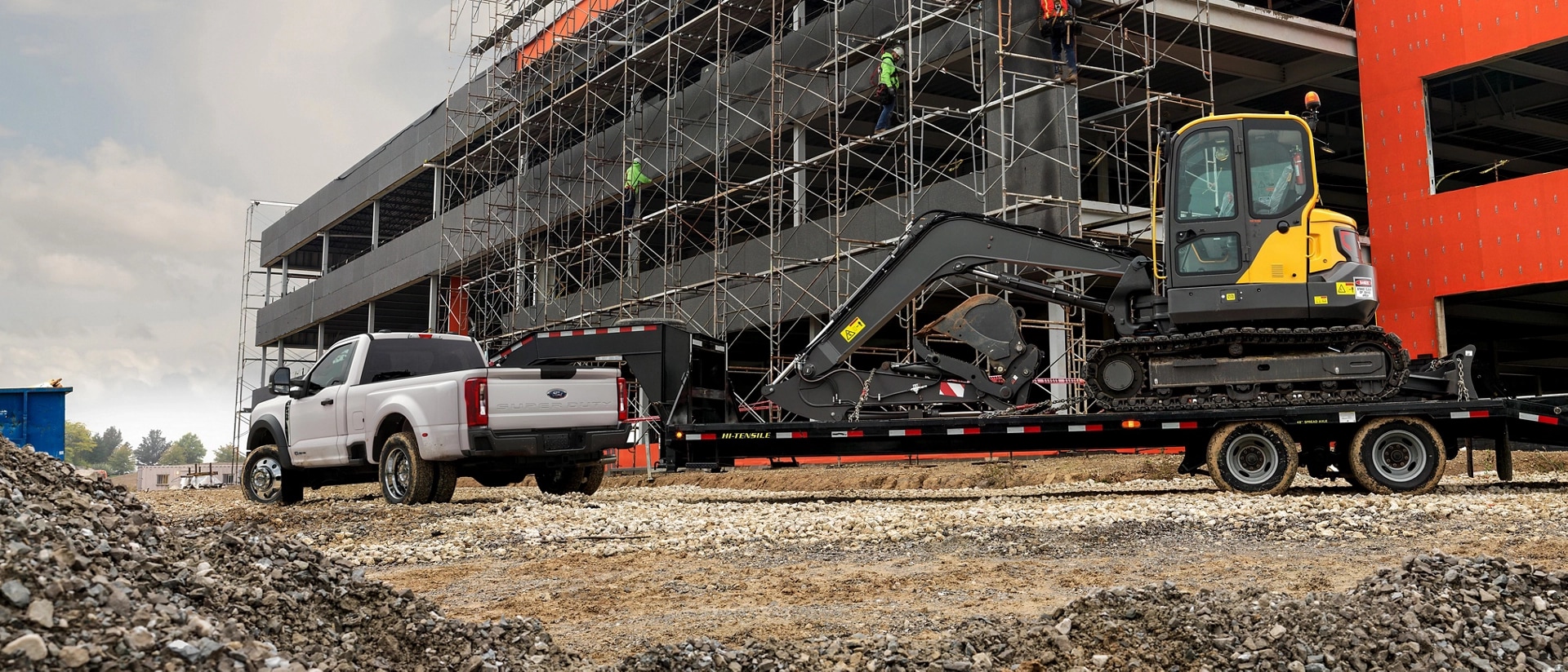 2026 Ford Super Duty with trailer with backhoe on it