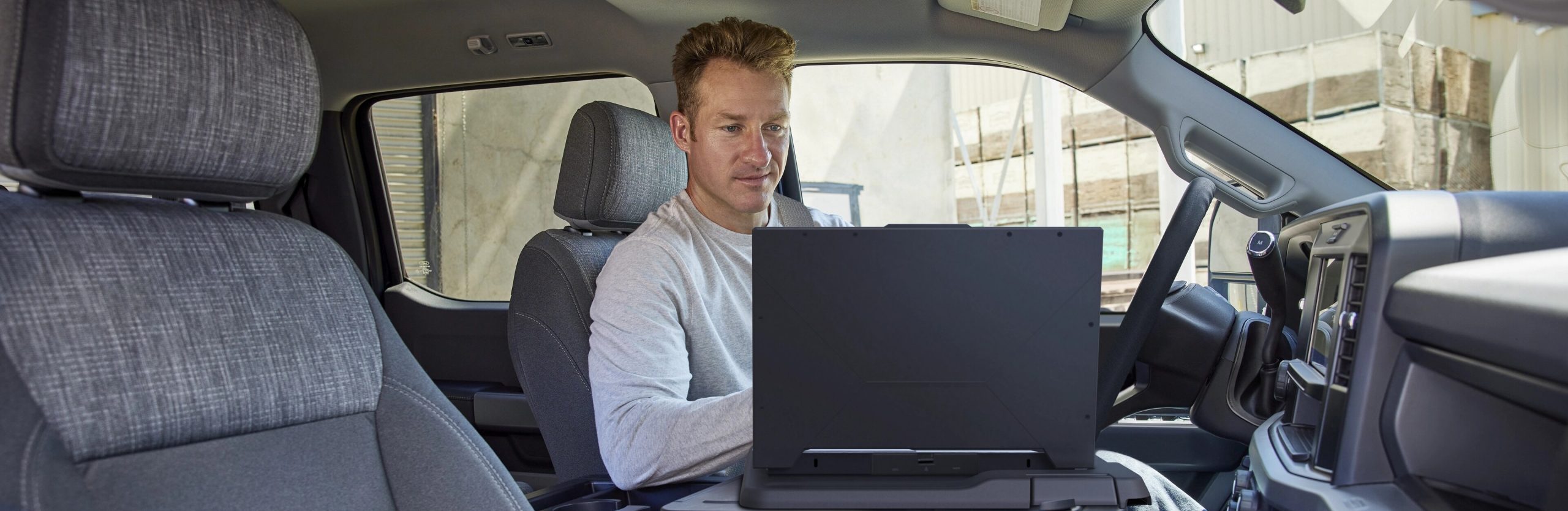 Person working on laptop in Super Duty