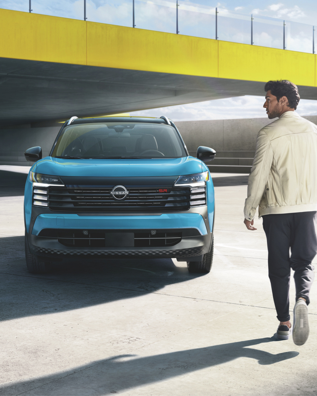 Driver approaching parked Nissan kicks