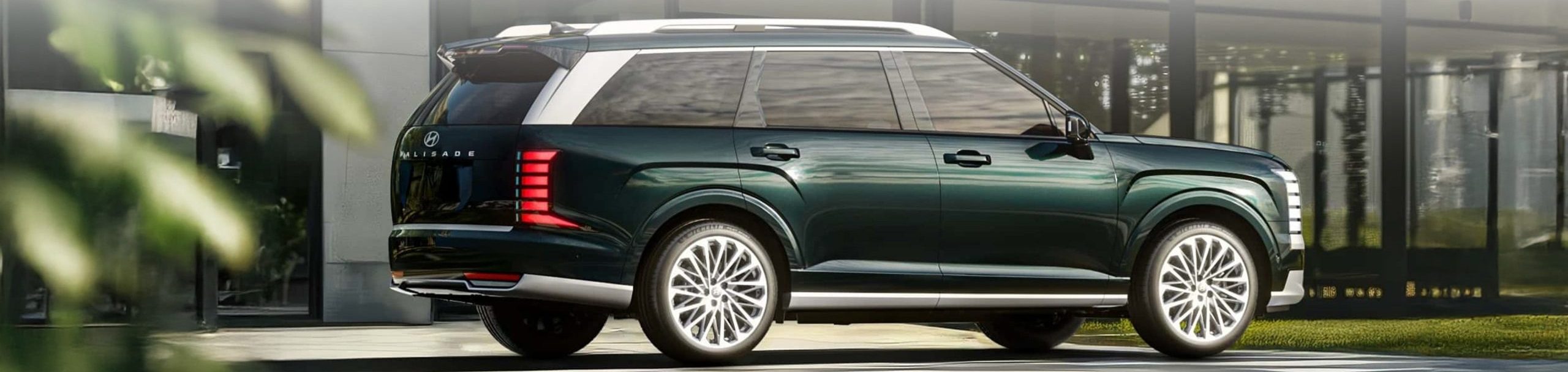 Side view of 2026 Palisade parked in front of modern building