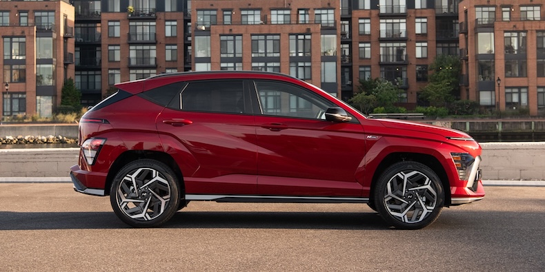 Exterior from the side of a red 2025 Hyundai Kona.
