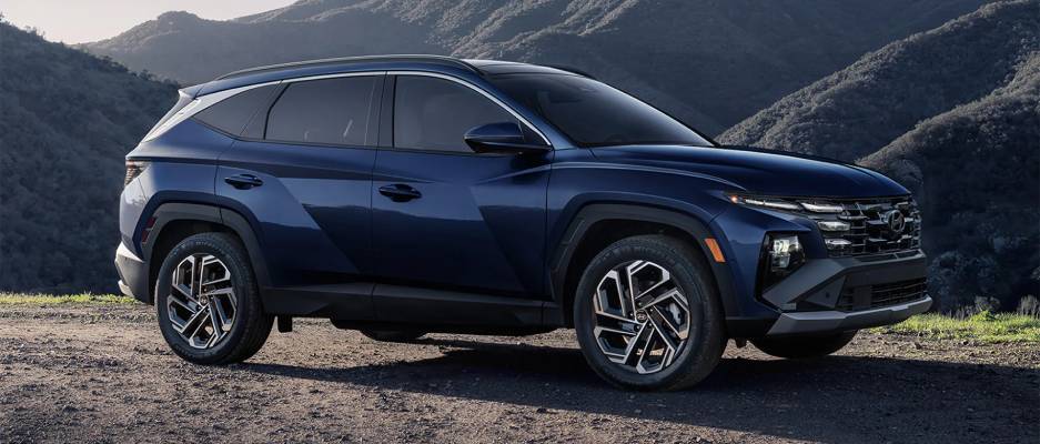 A side view of a dark blue 2026 Hyundai Tucson. New 2026 Hyundai Tucson for sale at Calgary Hyundai in Calgary, AB