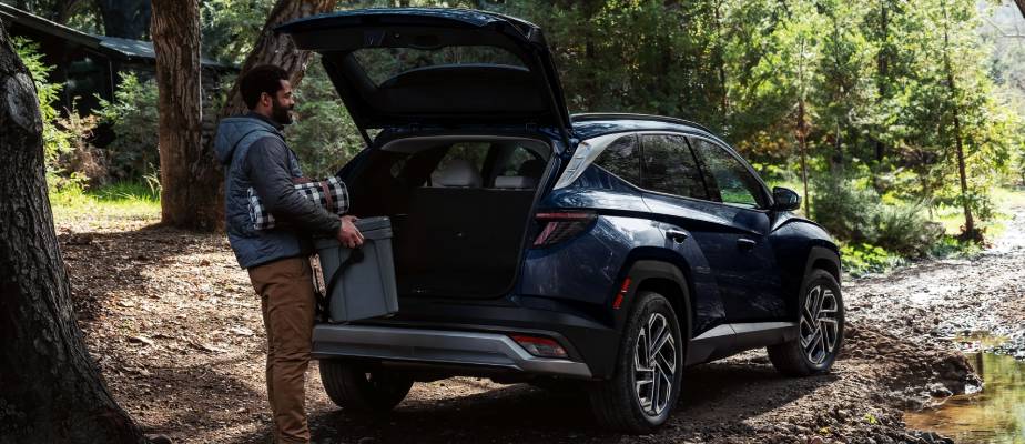 A man loads up the trunk of a 2026 Hyundai Tucson. New 2026 Hyundai Tucson Cargo Capacity at Calgary Hyundai in Calgary, AB