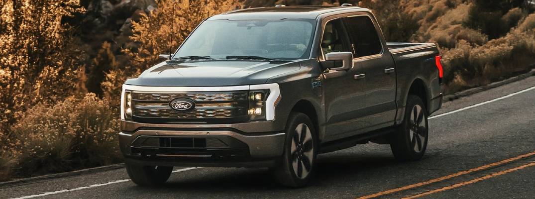 Ford Lightning driving on road during day time