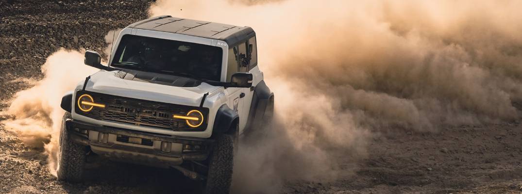 26 bronco driving through dust