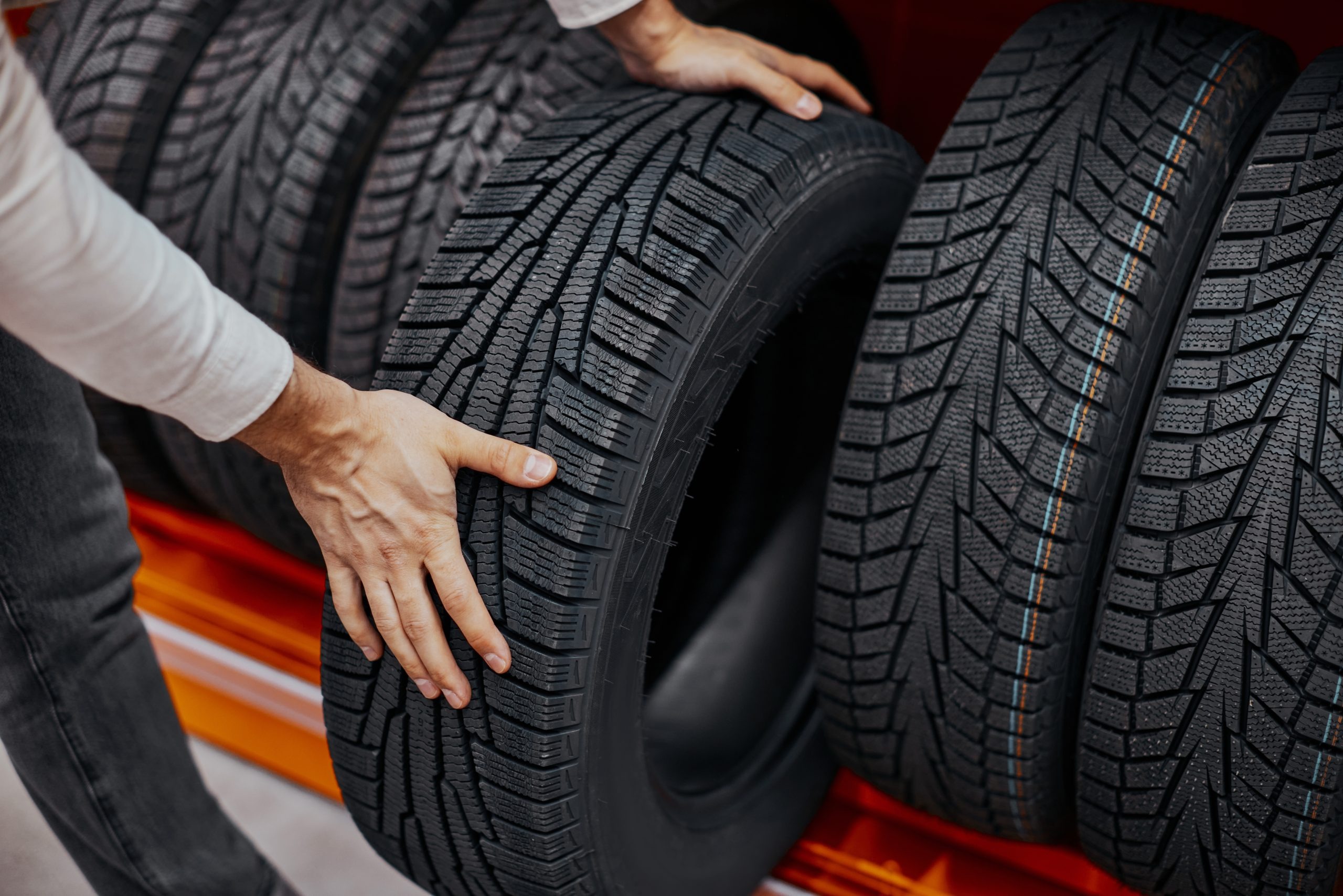 imgi_16_closeup-mans-hand-with-car-tires-scaled