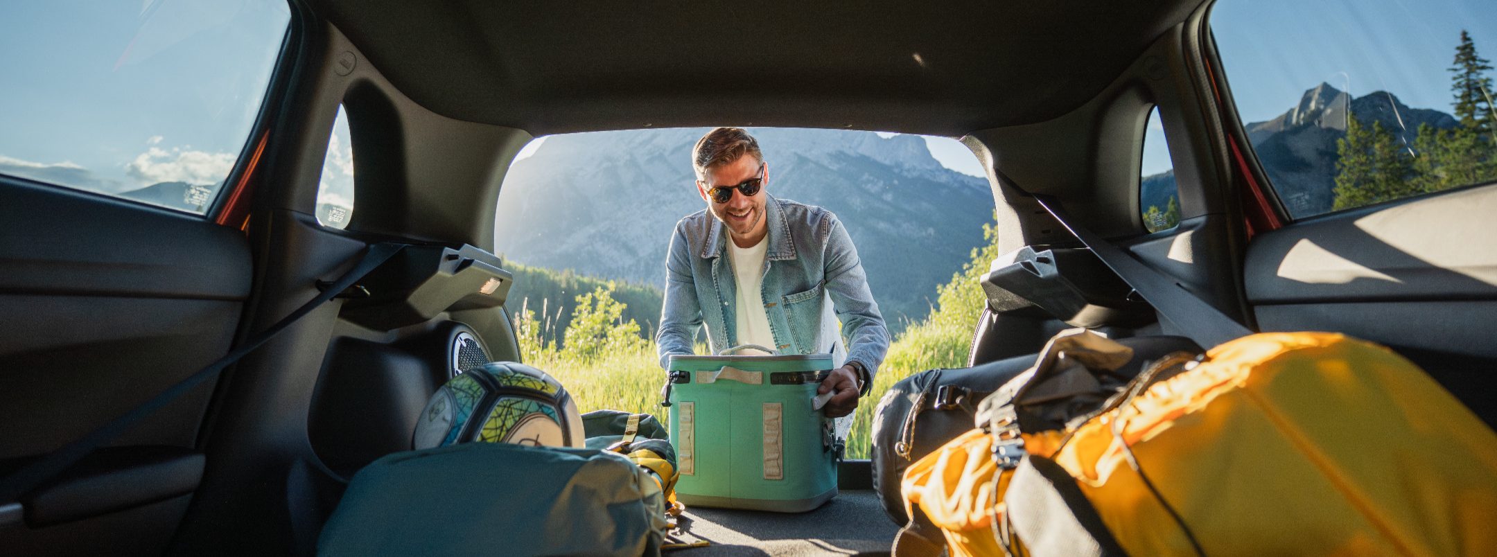 Man arranging bags in the 2026 Mitsubishi RVR 