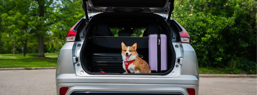 2026 Mitsubishi Eclipse Cross with a corgi and luggage in the trunk of the car