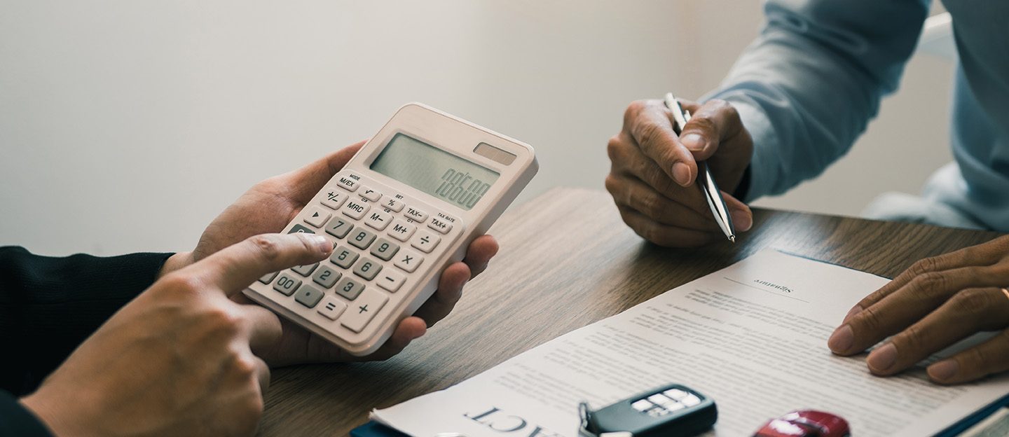 Finance manager of the car showroom is calculating the cost of reserving a new car for the customer while signing a car purchase contract.