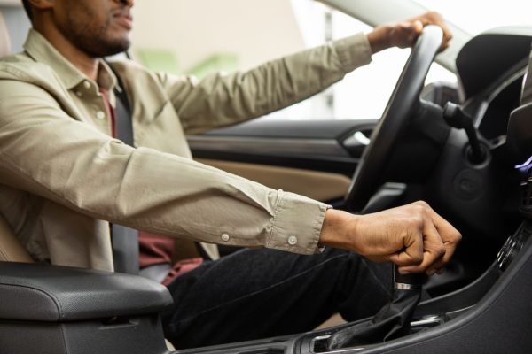 Interior shot of a man driving a vehicle.