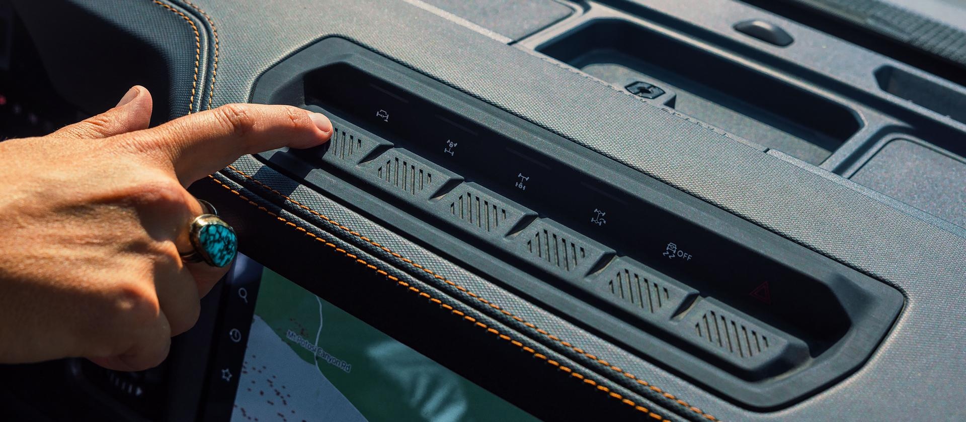 Person pointing at the different 2026 Ford Bronco drive type buttons