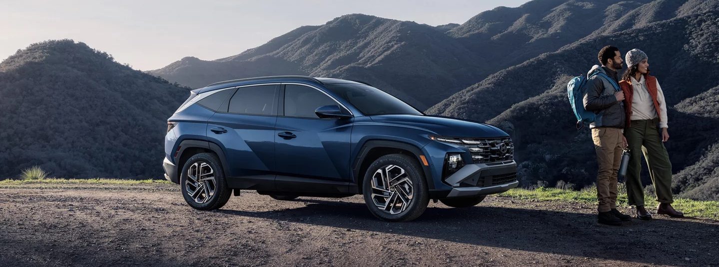 2026 Hyundai Tucson next to two people hiking