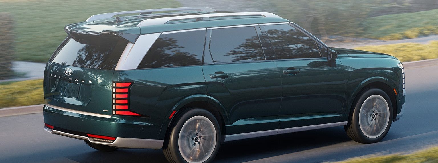 2026 Hyundai Palisade driving past green trees