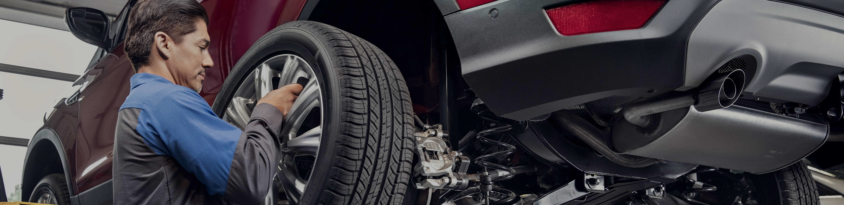 technician installing tire on vehicle