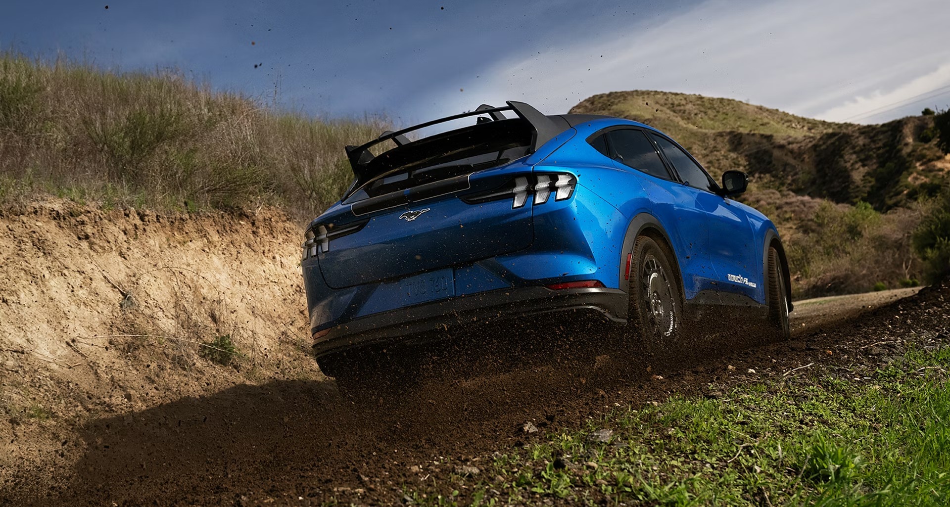 2025 Ford Mustang Mach-E driving on dirt terrain
