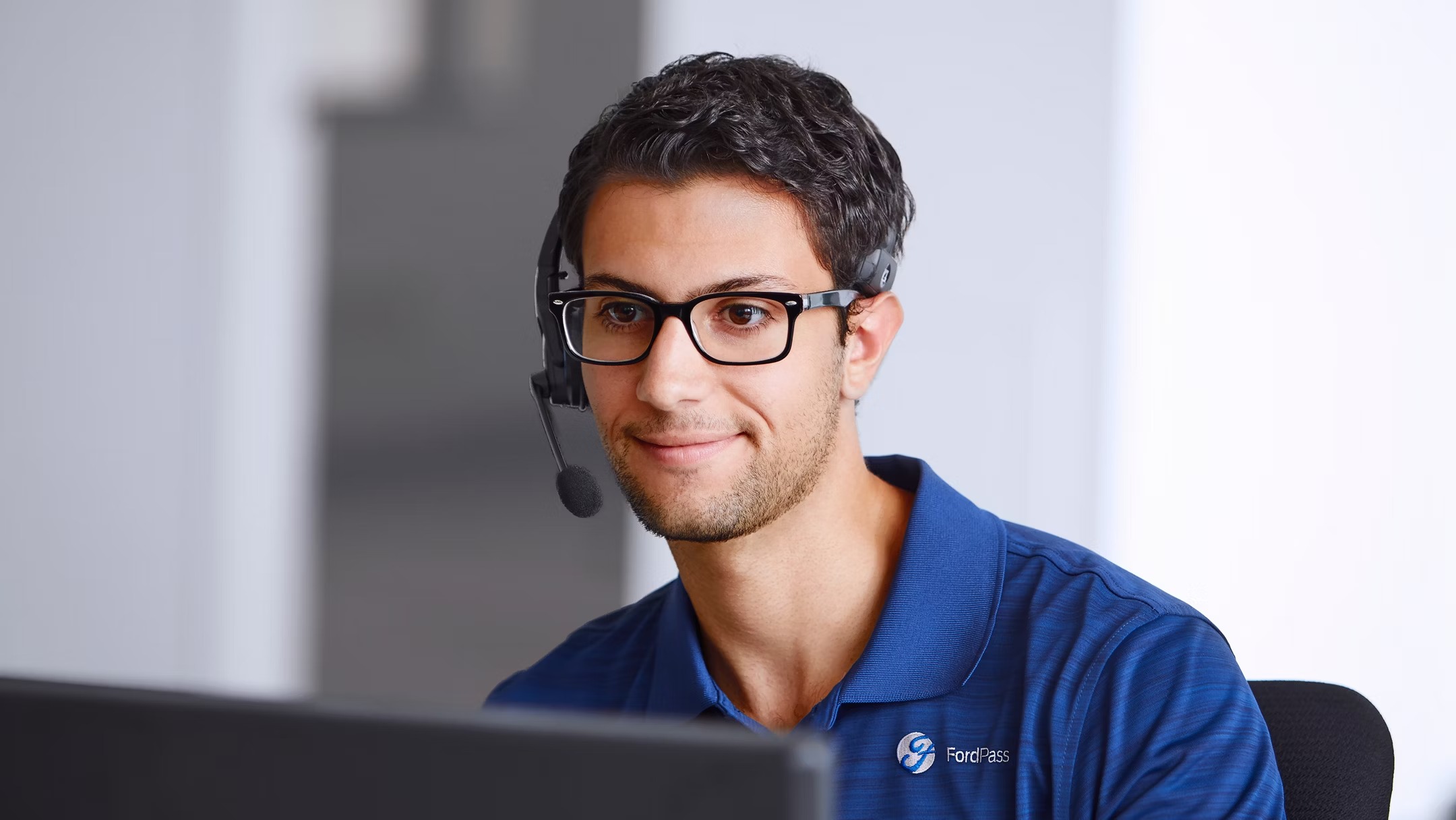 Unknown person using headset and looking at computer