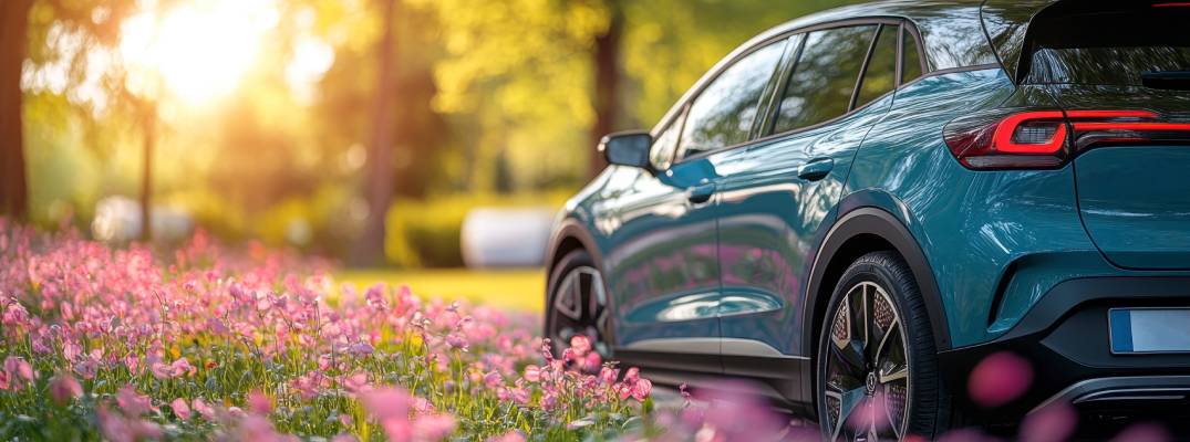 Vehicle parked in field with flowers