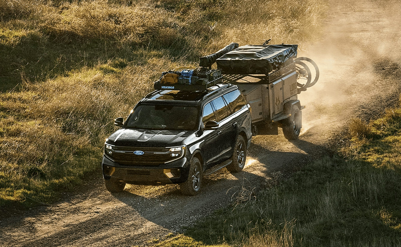 2026 Ford Expedition MAX pulling small trailer down dirt road