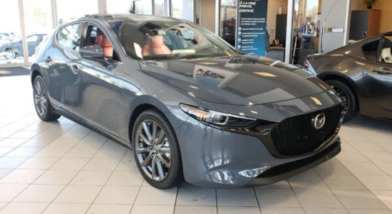 Grey Mazda3 hatchback displayed in a showroom, featured by Driven Auto Group Newmarket.