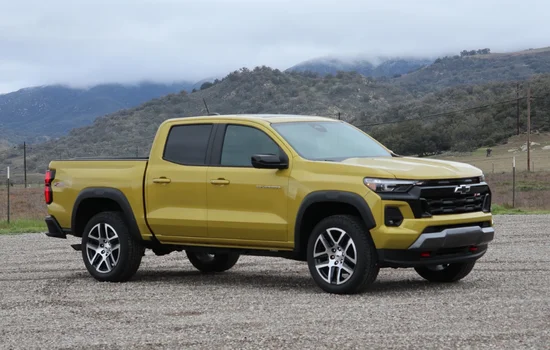 Yellow Chevrolet Colorado pickup truck parked in a scenic outdoor setting, highlighting versatile and efficient performance at Driven Auto Group Newmarket.