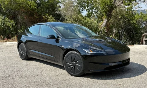 2026 Tesla Model 3 electric sedan in black parked outdoors, featured by DRIVEN Newmarket as a sleek and efficient EV for Canadian drivers.