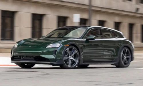 2026 Porsche Taycan Cross Turismo electric performance wagon driving in an urban setting, featured by DRIVEN Newmarket as a luxury EV option.