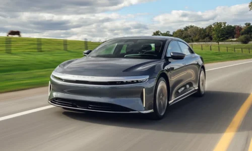 2026 Lucid Air luxury electric sedan driving on a scenic highway, featured by DRIVEN Newmarket as a premium long-range EV.
