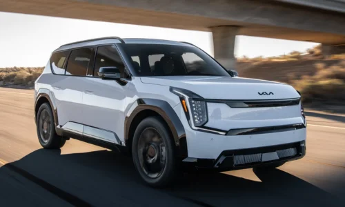 2026 Kia EV9 electric SUV driving on the highway, featured by DRIVEN Newmarket as a spacious three-row EV for Canadian families.