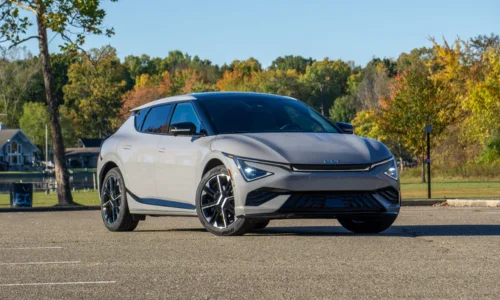 2026 Kia EV6 electric crossover parked outdoors near a scenic lake, featured by DRIVEN Newmarket as a stylish and high-performance EV.