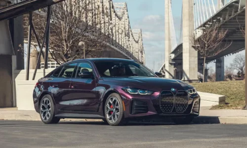 2026 BMW i4 electric luxury sedan parked in an urban setting, showcased by DRIVEN Newmarket as a premium EV option.