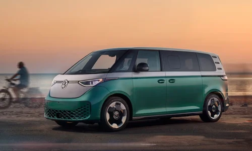 2025 Volkswagen ID. Buzz Microbus electric van parked near the waterfront at sunset, featured by DRIVEN Newmarket as a modern EV family vehicle.