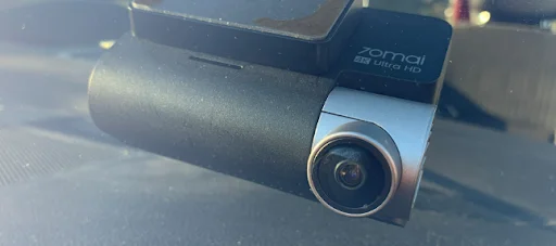 70Mai A810 dash cam mounted on a windshield with Ultra HD lens detail, featured by DRIVEN Newmarket for high-quality vehicle recording.