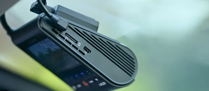 Viofo A329 dash cam mounted on a windshield showing rear camera port and memory card slot, featured by DRIVEN Newmarket for advanced vehicle recording.