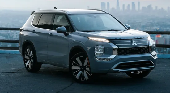 2026 Mitsubishi Outlander SUV parked overlooking a city skyline, featured by DRIVEN Newmarket as a spacious and modern family SUV.