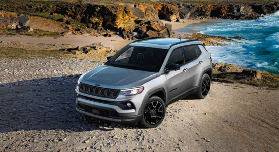 2026 Jeep Compass SUV parked on a rocky coastal trail overlooking the ocean, featured by DRIVEN Newmarket as a versatile compact SUV.